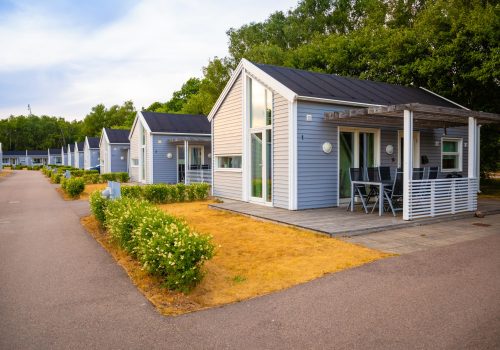 Raa, Sweden - June 17, 2018: Group of similar grey camping cabins in small swedish town Raa, Sveden